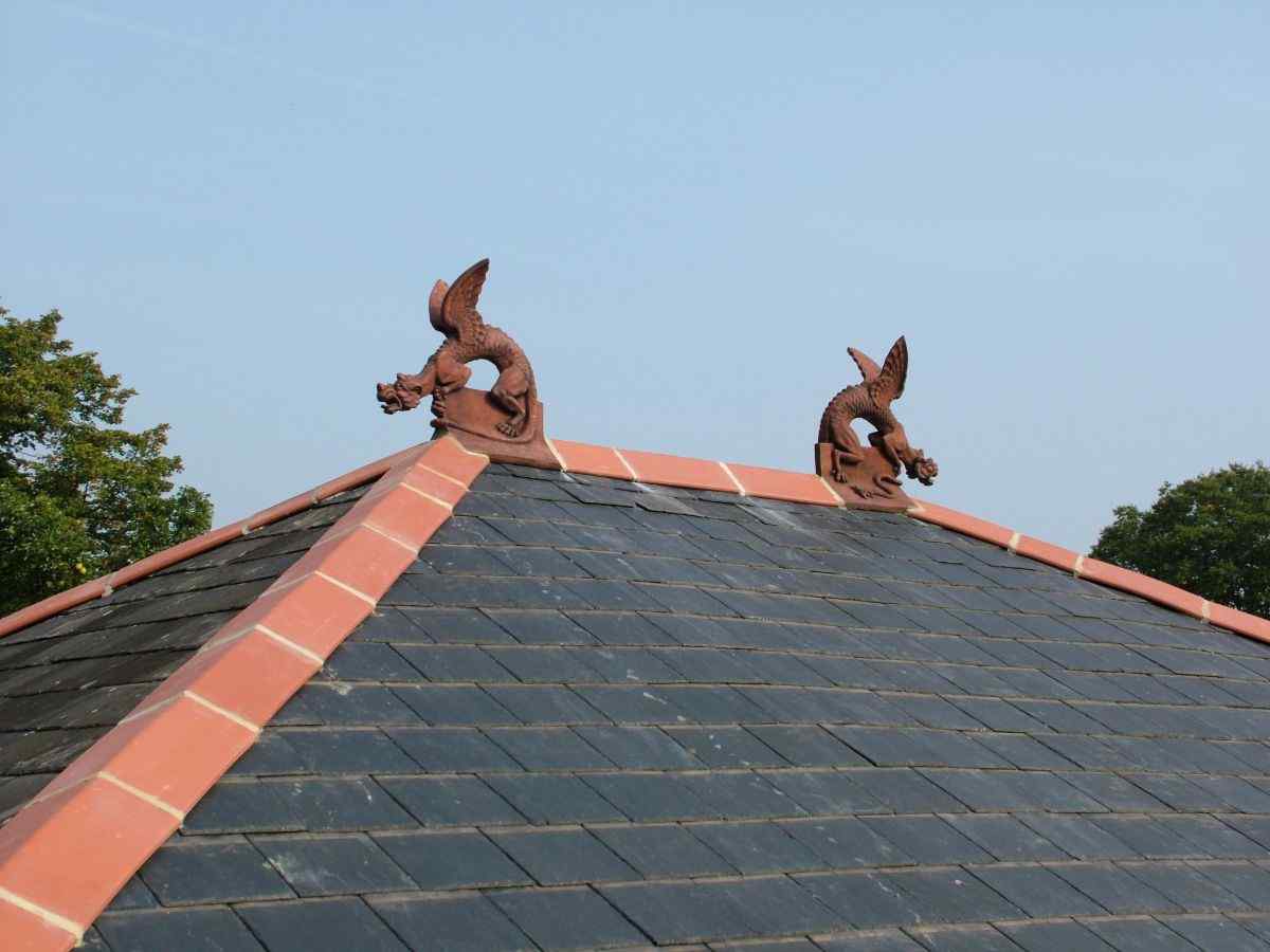 Winged dragon finials installed on a hip end roof
